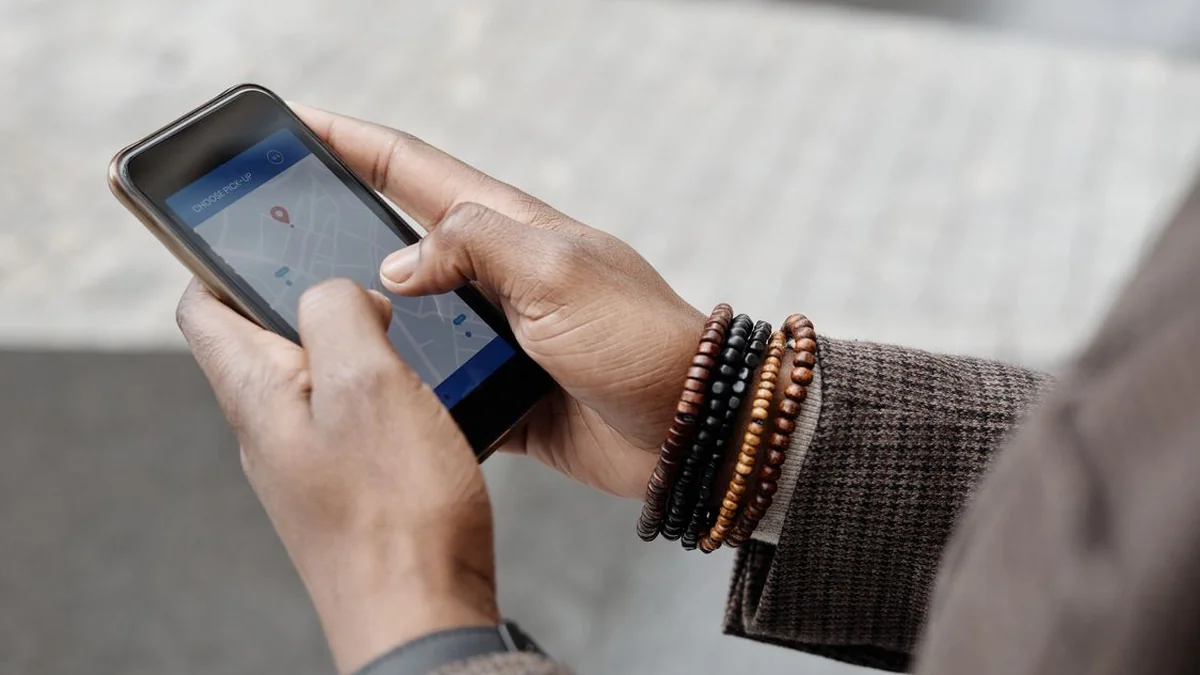 Customer holding a phone showing a map while searching for a local shop