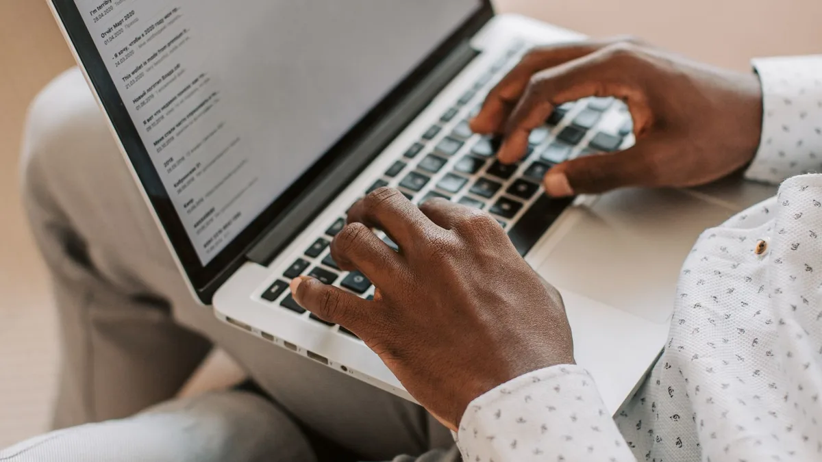 Business owner typing an email on a laptop