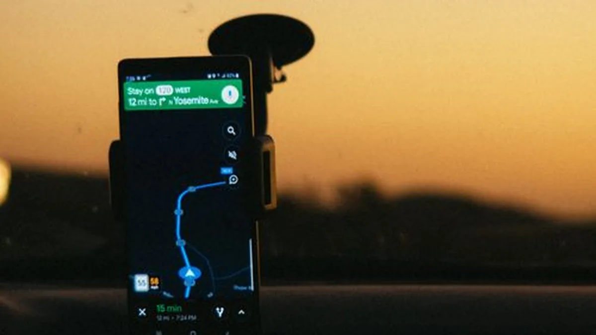 Phone showing map navigation in a car on the way to a business