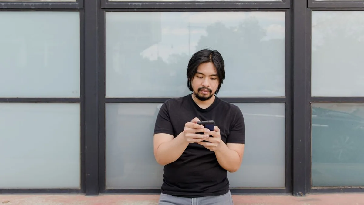 Customer using his phone to find a local business