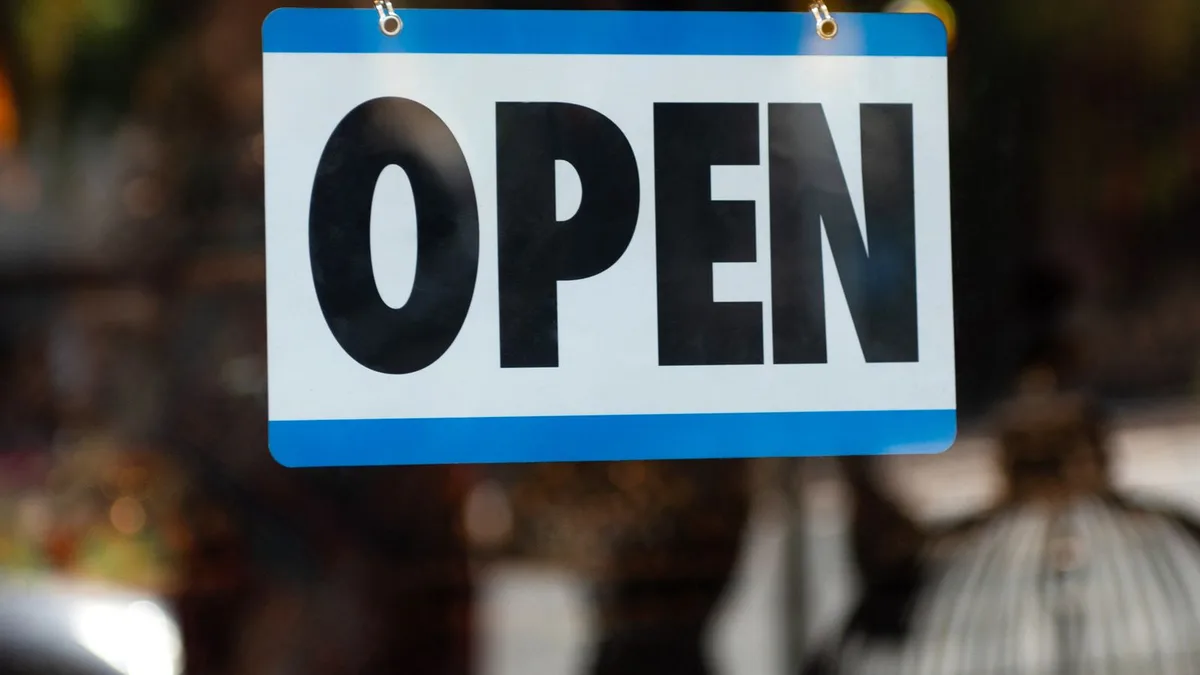 Open sign on a shop window after verification