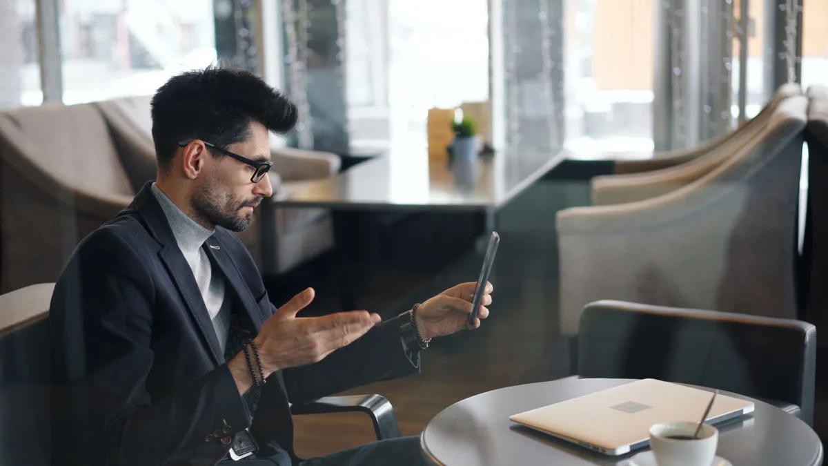 Business owner on a video call from a cafe table